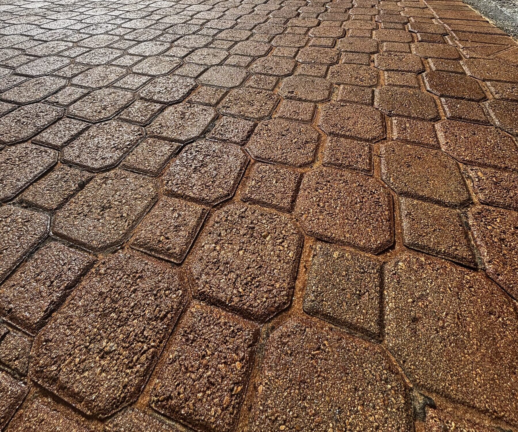 Warm-toned pavers with a restored, sealed finish